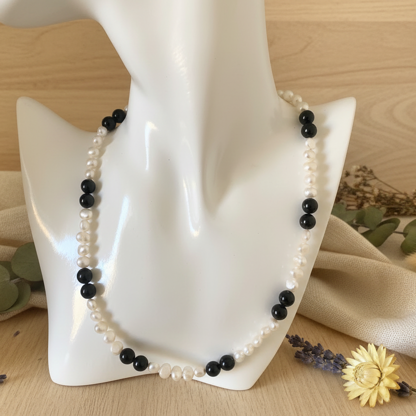 A beaded necklace with black onyx and white freshwater pearls