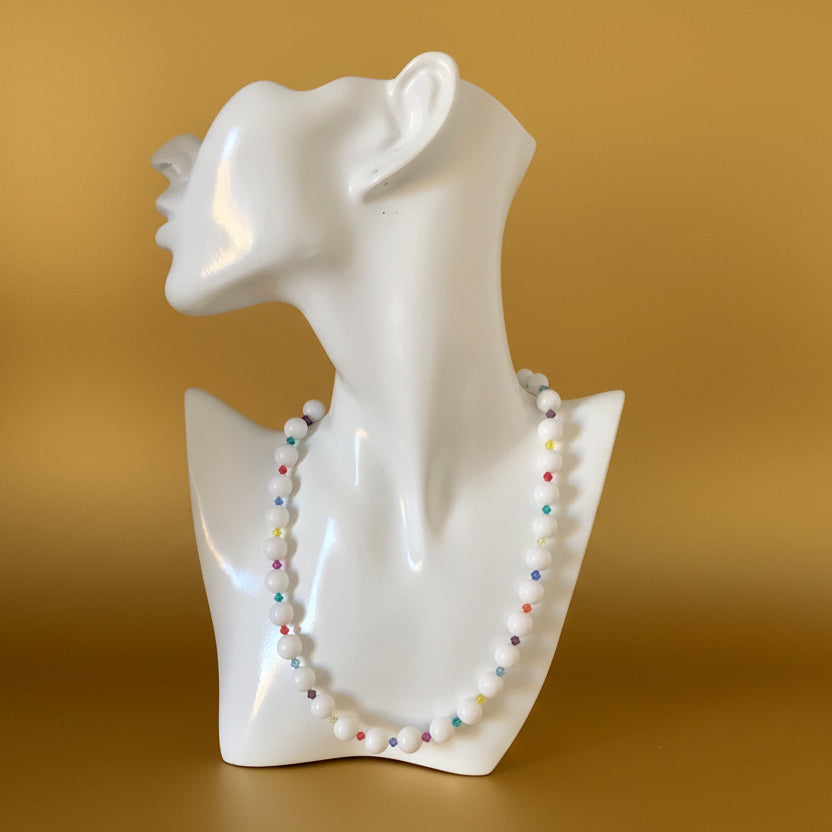 A beaded necklace with white quartz and multicolored Swarovski crystals